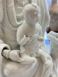A pair of Chinese Dehua blanc de Chine groups of Guanyin with a child and servants, 18th C.