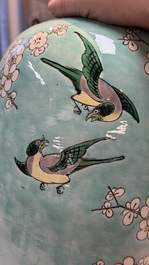 A pair of fine Chinese famille verte turquoise-ground 'Magpie and Prunus' jars with reticulated wooden covers, 19th C.