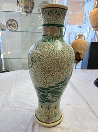 A Chinese verte biscuit 'Dragon Gate Carp 鯉躍龍門' vase on a wooden stand, Xuande mark, 19th C.