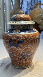A Chinese blue, white and iron-red decorated 'Mythical Animals' vase and cover, 19th C.