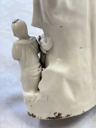 A pair of Chinese Dehua blanc de Chine groups of Guanyin with a child and servants, 18th C.
