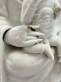 A pair of Chinese Dehua blanc de Chine groups of Guanyin with a child and servants, 18th C.