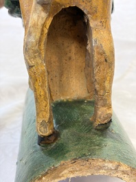 A pair of Chinese sancai-glazed 'Horseriders' roof tiles on wooden stands, Ming
