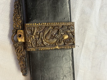 A Chinese palace guard sword 'Dao' inscribed 'Da Nei Shi Wei 大內侍衛', with lacquered wooden scabbard and gilt-bronze 'Dragon' mounts, Qing