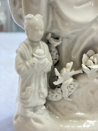 A pair of Chinese Dehua blanc de Chine groups of Guanyin with a child and servants, 18th C.