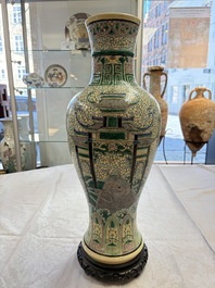 A Chinese verte biscuit 'Dragon Gate Carp 鯉躍龍門' vase on a wooden stand, Xuande mark, 19th C.