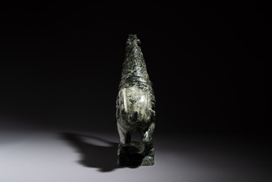 A large Chinese carved serpentine horse on a wooden stand, 20th C.