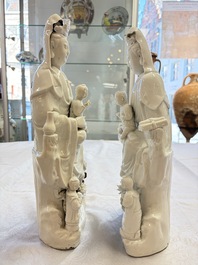A pair of Chinese Dehua blanc de Chine groups of Guanyin with a child and servants, 18th C.