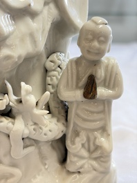 A pair of Chinese Dehua blanc de Chine groups of Guanyin with a child and servants, 18th C.