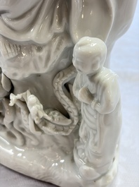A pair of Chinese Dehua blanc de Chine groups of Guanyin with a child and servants, 18th C.