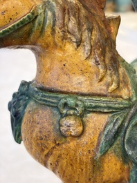 A pair of Chinese sancai-glazed 'Horseriders' roof tiles on wooden stands, Ming