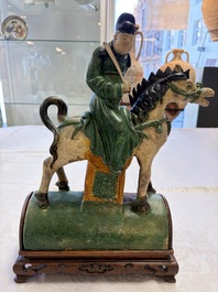 A pair of Chinese sancai-glazed 'Horseriders' roof tiles on wooden stands, Ming