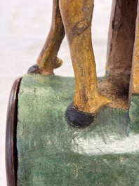 A pair of Chinese sancai-glazed 'Horseriders' roof tiles on wooden stands, Ming