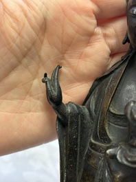 A Chinese bronze standing Guanyin with boy, Ming