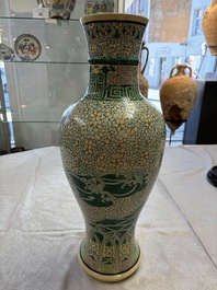 A Chinese verte biscuit 'Dragon Gate Carp 鯉躍龍門' vase on a wooden stand, Xuande mark, 19th C.