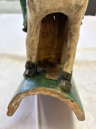 A pair of Chinese sancai-glazed 'Horseriders' roof tiles on wooden stands, Ming