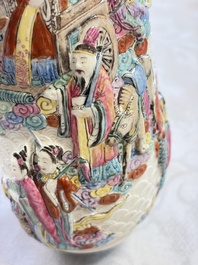 A pair of Chinese famille rose relief-moulded 'Immortals' vases, Qianlong mark, Republic