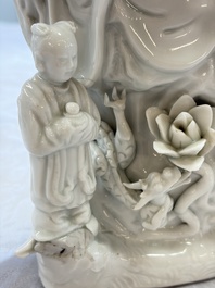 A pair of Chinese Dehua blanc de Chine groups of Guanyin with a child and servants, 18th C.
