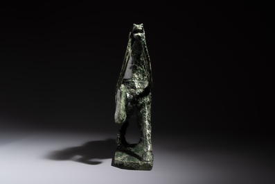 A large Chinese carved serpentine horse on a wooden stand, 20th C.