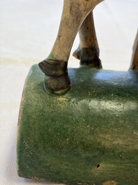 A pair of Chinese sancai-glazed 'Horseriders' roof tiles on wooden stands, Ming