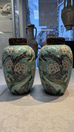 A pair of fine Chinese famille verte turquoise-ground 'Magpie and Prunus' jars with reticulated wooden covers, 19th C.