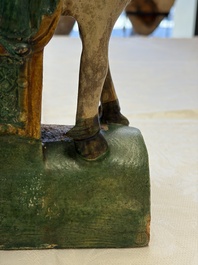 A pair of Chinese sancai-glazed 'Horseriders' roof tiles on wooden stands, Ming