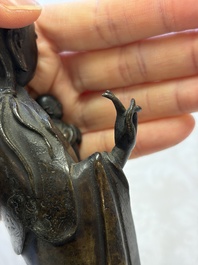 A Chinese bronze standing Guanyin with boy, Ming