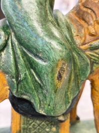 A pair of Chinese sancai-glazed 'Horseriders' roof tiles on wooden stands, Ming