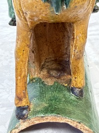A pair of Chinese sancai-glazed 'Horseriders' roof tiles on wooden stands, Ming