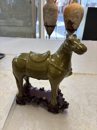 A Chinese teadust-glazed model of a horse on a wooden stand, Republic