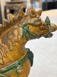A pair of Chinese sancai-glazed 'Horseriders' roof tiles on wooden stands, Ming
