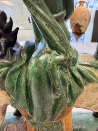 A pair of Chinese sancai-glazed 'Horseriders' roof tiles on wooden stands, Ming