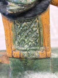 A pair of Chinese sancai-glazed 'Horseriders' roof tiles on wooden stands, Ming