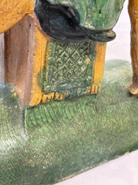 A pair of Chinese sancai-glazed 'Horseriders' roof tiles on wooden stands, Ming