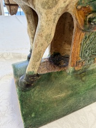 A pair of Chinese sancai-glazed 'Horseriders' roof tiles on wooden stands, Ming