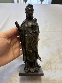 A Chinese bronze standing Guanyin with boy, Ming