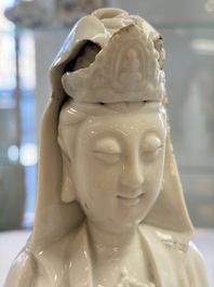 A pair of Chinese Dehua blanc de Chine groups of Guanyin with a child and servants, 18th C.