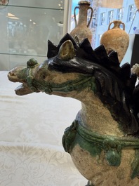 A pair of Chinese sancai-glazed 'Horseriders' roof tiles on wooden stands, Ming