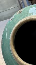 A pair of fine Chinese famille verte turquoise-ground 'Magpie and Prunus' jars with reticulated wooden covers, 19th C.