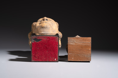 A Khmer-style carved stone head and a carved stone head of a deity, Thailand and Cambodia, 20th C. or earlier