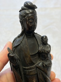 A Chinese bronze standing Guanyin with boy, Ming