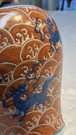 A Chinese blue, white and iron-red decorated 'Mythical Animals' vase and cover, 19th C.