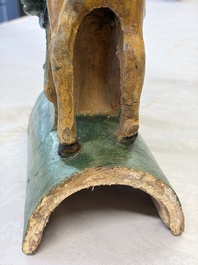 A pair of Chinese sancai-glazed 'Horseriders' roof tiles on wooden stands, Ming