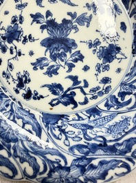 Eleven Chinese blue and white gadrooned 'Flowers and Peacocks' plates, Kangxi