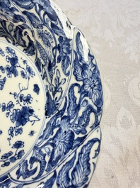 Eleven Chinese blue and white gadrooned 'Flowers and Peacocks' plates, Kangxi