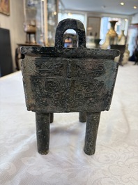 An inscribed Chinese archaic bronze food vessel with Taotie design, Ding 鼎, Western Zhou