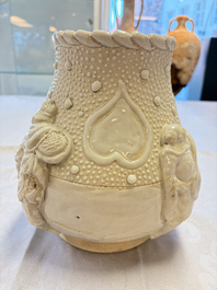 A Chinese Nanking white-glazed 'hu' vase with figural relief design, 19th C.