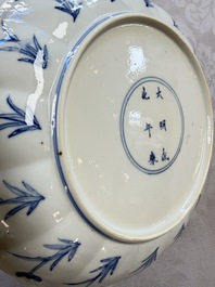 A Chinese blue and white 'Elegant Lady with Two Boys' plate with a 'Lotus Scroll' border, Kangxi