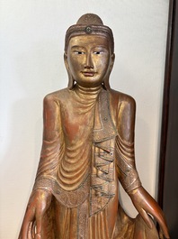 A very large Burmese mica-inlaid gilt-lacquered wooden Mandaly Buddha, 20th C.