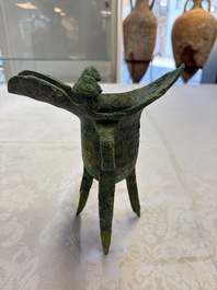 A Chinese archaic bronze wine vessel with Taotie design, Jue 爵, late Shang
